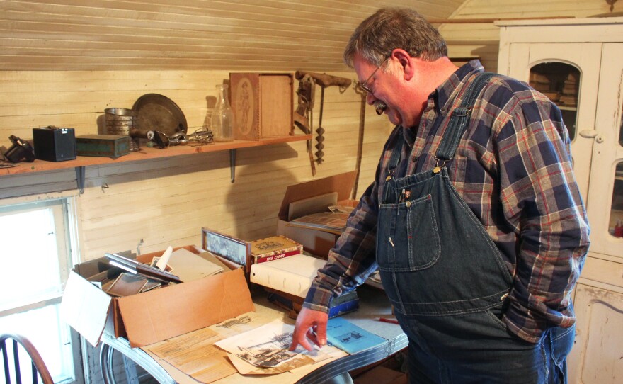 Donn Teske looks through family heirlooms in a house where his ancestors lived near Wheaton, Kans.