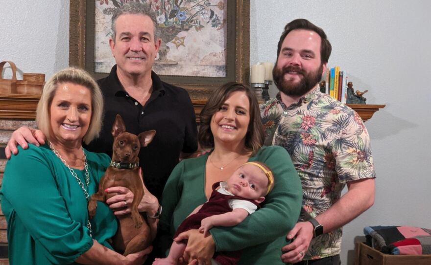 Andrew Maxwell is pictured here with his wife Kari, his daughter and in-laws in November 2020.
