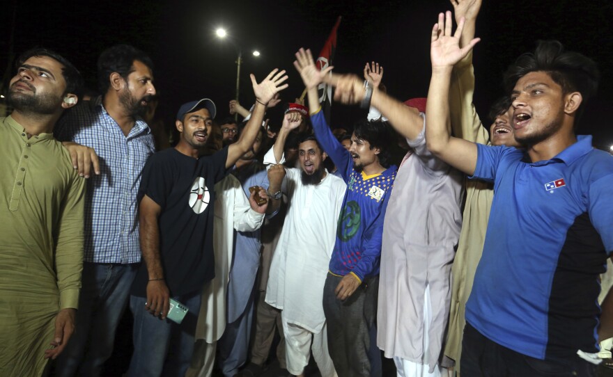Supporters of an opposition party celebrate the success of a no-confidence vote against Prime Minister Imran Khan, in Karachi, Pakistan, Sunday, April 10, 2022.
