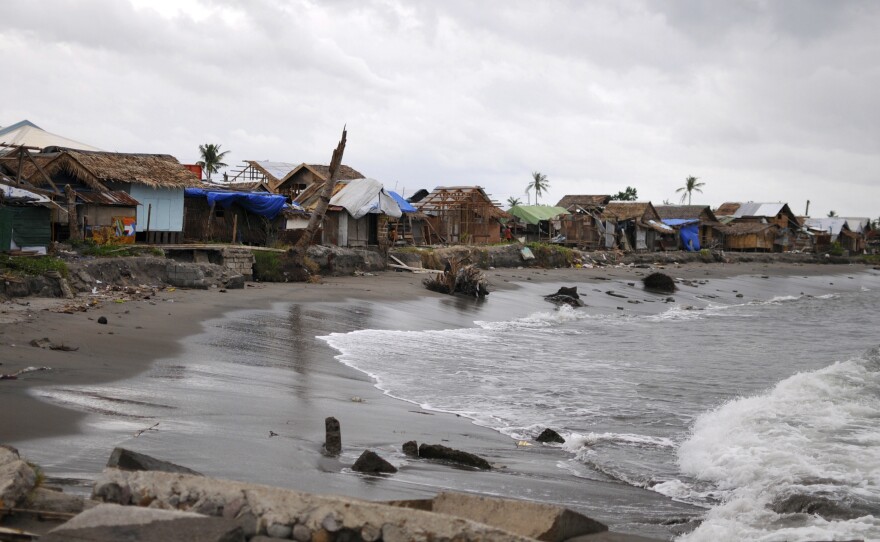 A coastal village of Tanauan township, Leyte province in central Philippines, sits abandoned on Friday after its residents evacuated.