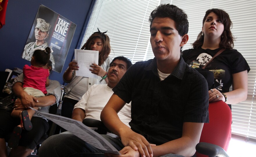 Victor Arriaga and his family wait inside the Marine Corps recruiting office before he starts boot camp. Victor decided to join the Marines in the hopes that he could help bring his mother back from Mexico. She was deported when he was a freshman in high school.