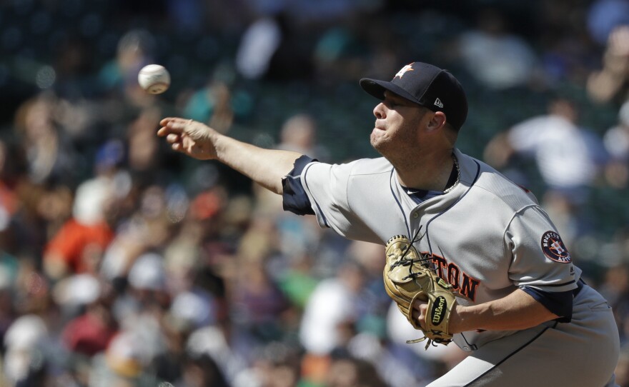 Houston Astros relief pitcher Brad Peacock delivers the ball during an Aug. 1 game against the Seattle Mariners in Seattle. A month later, he became the third known player in the league diagnosed with hand, foot and mouth disease this season.