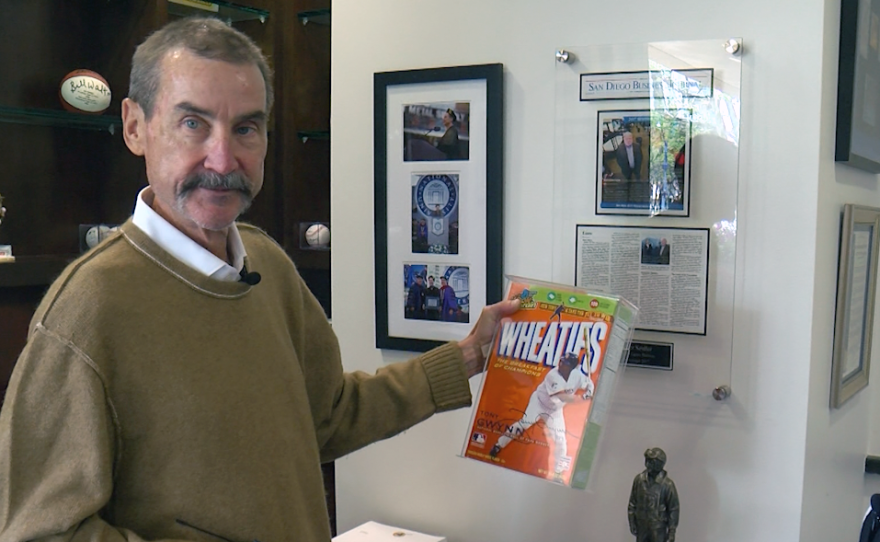 Peter Seidler holds a Wheaties box featuring Tony Gwynn.
