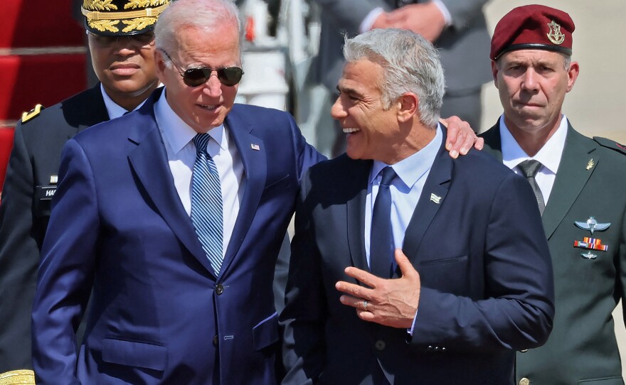 President Biden threw his arm around the shoulders of Israeli Prime Minister Yair Lapid after he arrived at Ben Gurion Airport in Tel Aviv.