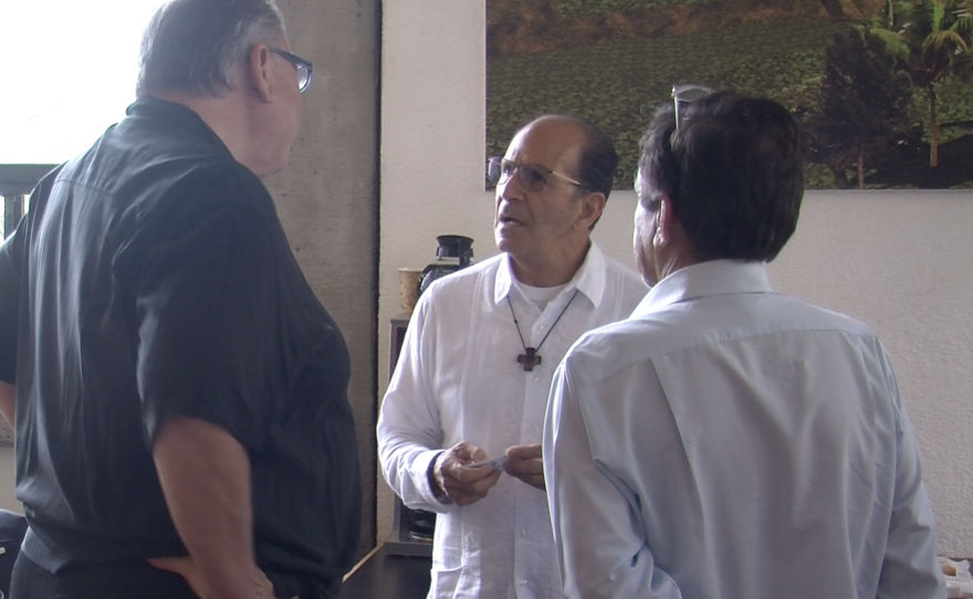 Father Alejandro Solalinde talks to Carlos Mora Álvarez of the Migrant Attention Council in Tijuana, Sept. 1, 2015.