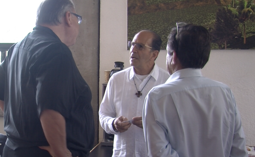 Father Alejandro Solalinde talks to Carlos Mora Álvarez of the Migrant Attention Council in Tijuana, Sept. 1, 2015. 