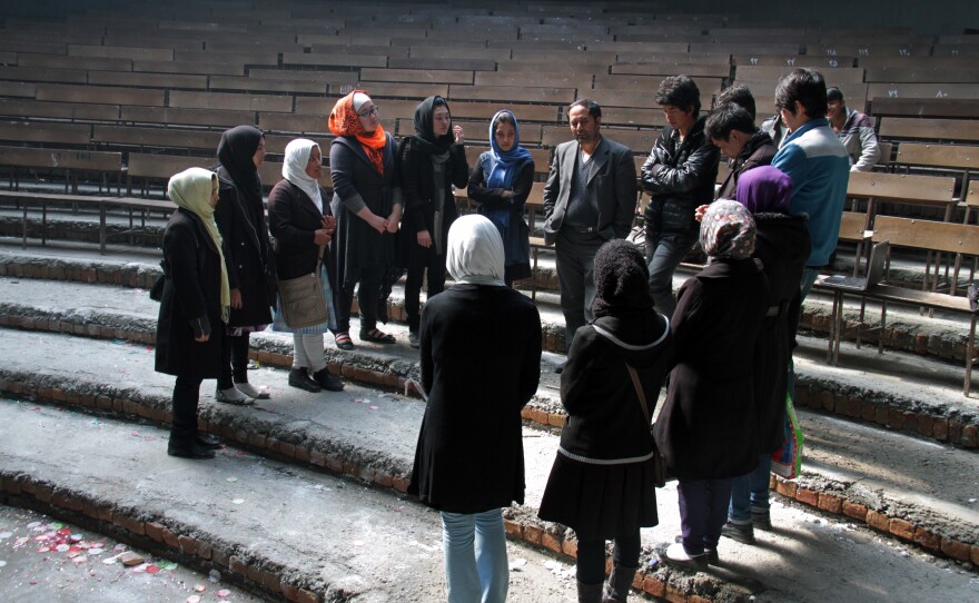 Royesh (center) holds an impromptu class in the auditorium of Marefat School in Kabul.