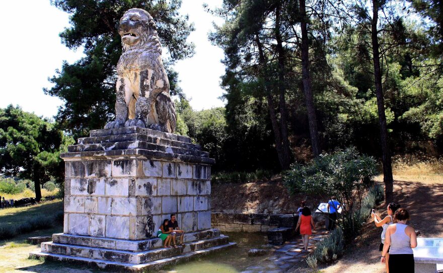Tourists visit the Lion of Amphipolis on Aug. 18. The large tomb, its occupant unknown, was found nearby. But Greek authorities have not yet allowed the public to visit the site of the tomb.