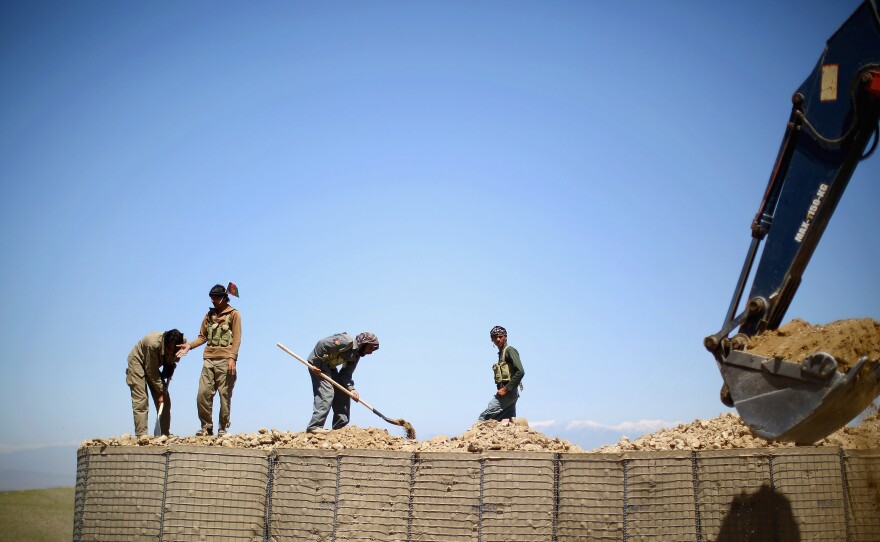 Workers set up a local police checkpoint in Nangahar Province, just a few miles from the Pakistan border. Many insurgent fighters slip over the mountains from Pakistan. That's why this checkpoint is being set up.