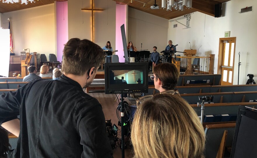 Rachel Earnest ( center at video monitor) directs a scene at Community Presbyterian Church for her short film "Moving Out."