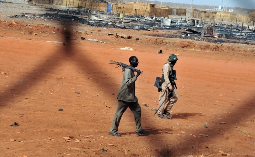 Sudanese soldiers walk in the oil town of Heglig on April 24. South Sudanese forces occupied Heglig last month. The international community called on the South to pull out, which it says it did.