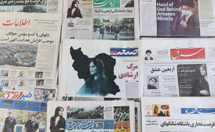 Newspapers with a cover picture of Mahsa Amini, a woman who died after being arrested by Iran's morality police, are seen in Tehran, Sept. 18, 2022.