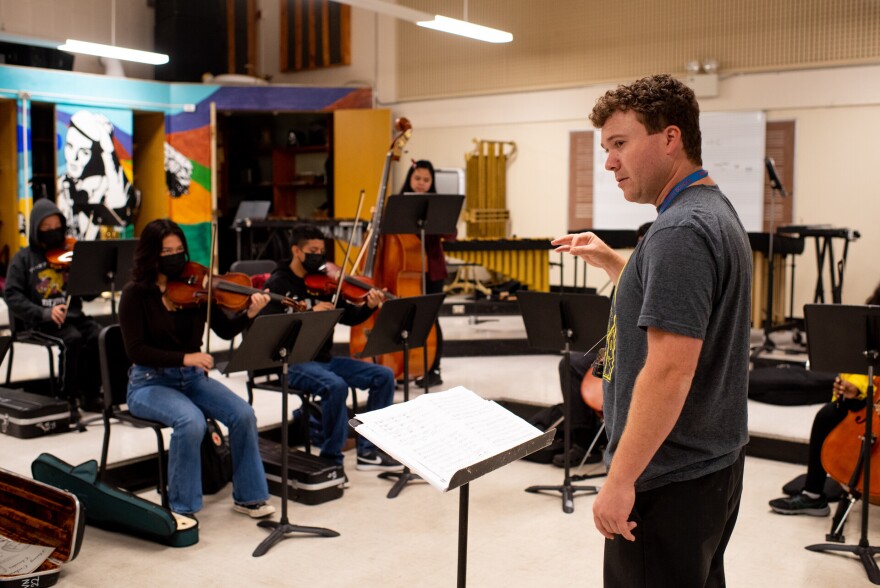 Music director Andrew Wilke conducts orchestra class at Richmond High School in Richmond on Wednesday, October 5, 2022. Richmond High School’s arts programming would benefit from Prop 28, a measure that would roughly double the amount of funding that California gives schools for arts and music education. “We could use it, desperately,” said Wilke. “To not have to worry about finances on top of teaching seven classes would make my job more manageable, which would make me a better teacher and the kids happier,” Wilke said.