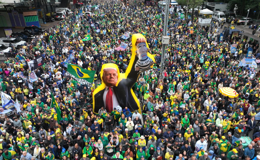 Supporters of opposition presidential candidate Flavio Bolsonaro march with an effigy of U.S. President Donald Trump holding a doll depicting Brazilian President Luiz Inacio Lula da Silva as a prisoner, during an Independence Day event in Sao Paulo, Brazil, Monday, Sept. 7, 2026, the month before the general election.