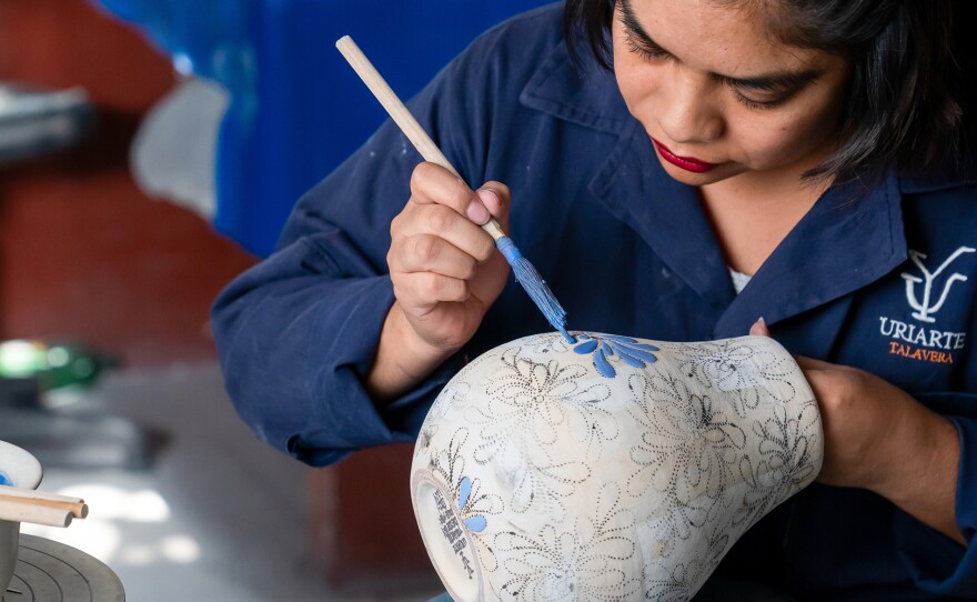 A Talavera pottery worker paints a piece of pottery at Uriarte Talavera in Puebla, Mexico. Featured in "Mexico Made With Love."