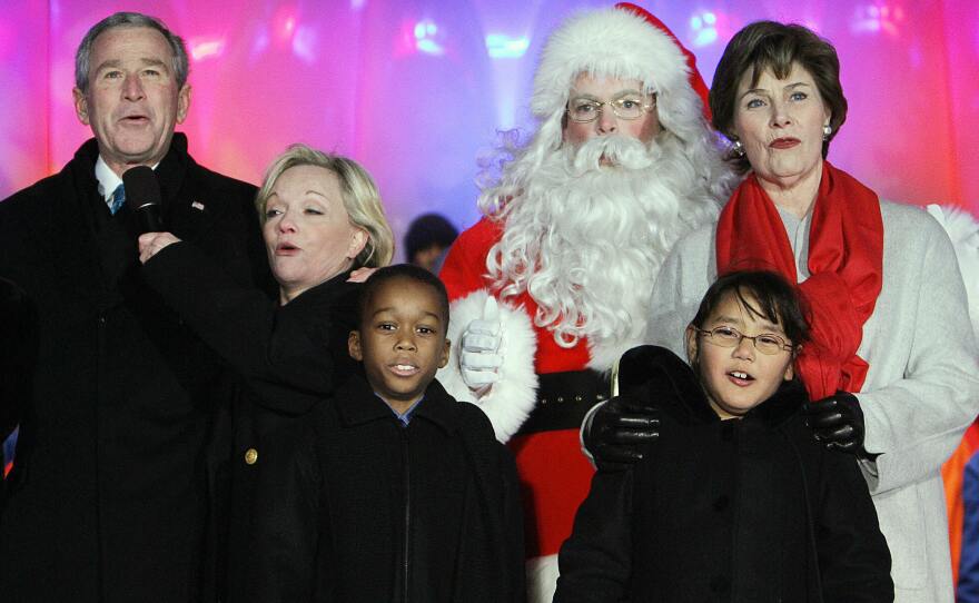 President George W. Bush and first lady Laura Bush sing a Christmas carol with Cathy Rigby and Santa Claus after lighting the National Christmas Tree in 2006.