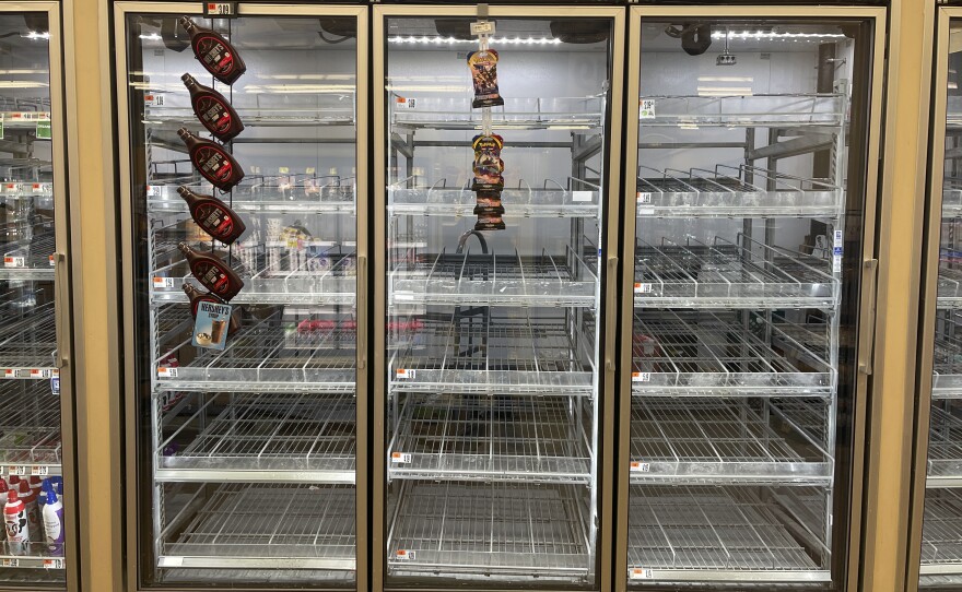The milk shelf is mostly empty at a Giant grocery store on Tuesday in Washington.