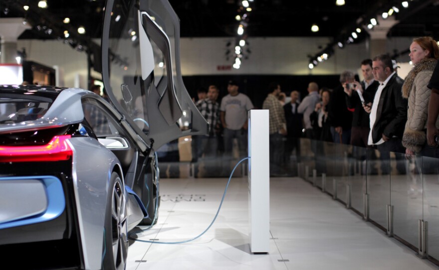 Attendees at the Los Angeles Auto Show look at the BMW i8 plug-in hybrid concept car. Toyota's Prius is the best-selling hybrid on the market, but almost every carmaker has some form of hybrid technology.
