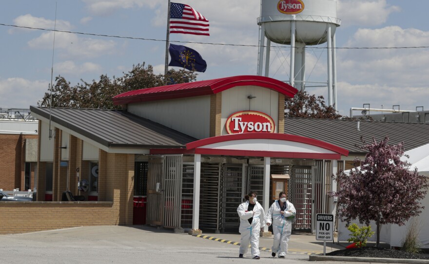 Workers are shown leaving the Tyson Foods pork processing plant in Logansport, Ind., in May. A House subcommittee is investigating the Trump administration's handling of COVID-19 outbreaks at meatpacking plants, focusing on the Occupational Safety and Health Administration as well as major companies Tyson, Smithfield and JBS.