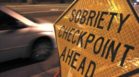 A car approaches a sobriety checkpoint set up along a busy street in Albuquerque, New Mexico, in this file photo, Dec. 29, 2011.  