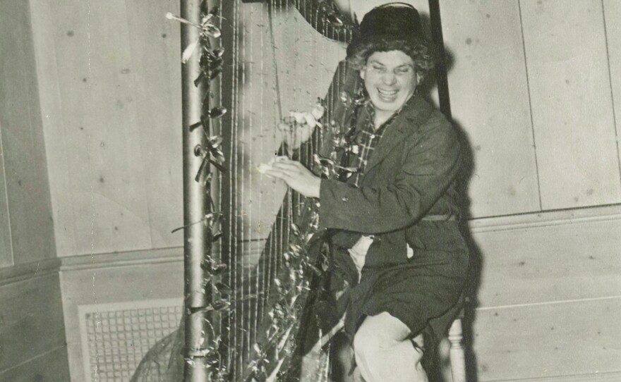 Harpo Marx with the surrealist harp sent to him by Salvador Dalí.