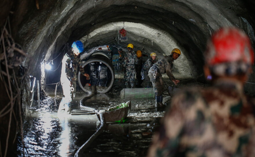 The Nepali Army conducts a search-and-rescue operation on Sept. 10 inside the Chilime Hydropower Station tunnel days after the deadly flash floods and mudslides in Nepal's Rasuwa district in August. In the wake of the disaster, concerns are being raised about the impact of the construction of hydropower plants and dams in the Himalayas.