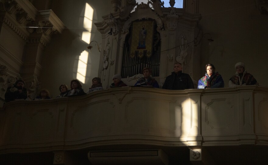 People attend services at the Ukrainian church in Bologna, Italy, when the community was praying for the tensions that were already looming between Russia and Ukraine in January 2022. Many caregivers use their free time to attend church. This is not only a way to ease the pain of distance but also to get together with friends with whom they can share common concerns.