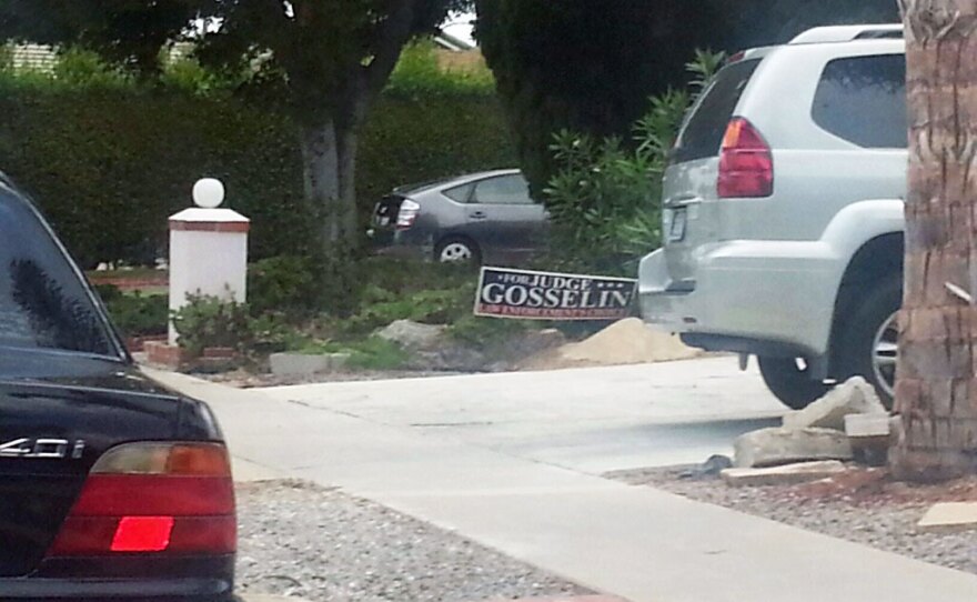 One of Ken Gosselin's campaign signs in the front yard of a home. It reads "For Judge, Gosselin." Gosselin's campaign signs have come under fire for portraying the candidate as an incumbent.