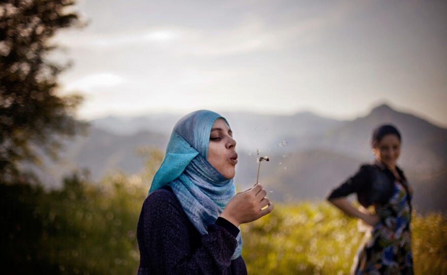 Ayat walks along the mountain roads of northern Dagestan, a Republic of Russia in the Caucasus. June 25, 2011