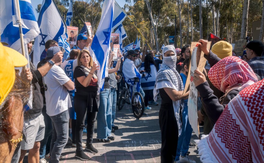 Pro-Israel counter-protesters hold Israeli flags outside the pro-Palestinian encampment at UC San Diego, May 5, 2024. 