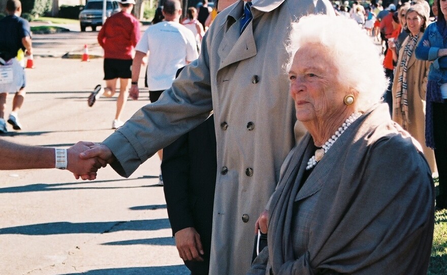Former president George H.W. Bush and Barbara Bush greet runners participating in the Houston Marathon on Jan. 13, 2008. The route took participants past the Bushes church, St. Martin's Episcopal.