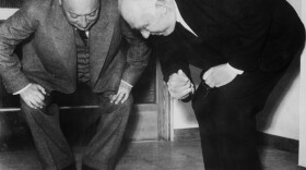 Physicists Wolfgang Pauli, left, and Niels Bohr demonstrating a "tippe top" toy in 1954. Tippe tops flip upside down to spin on their handle and are part of the "Secret Science of Toys" festival at the Fleet Science Center on Jan. 21.

