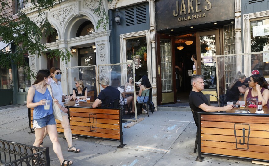 Patrons at Manhattan bar Jake's Dilemma dined outdoors on the first day it was allowed New York City. Mayor Bill De Blasio indefinitely delayed the opening of restaurants and bars for indoor dining on Wednesday.