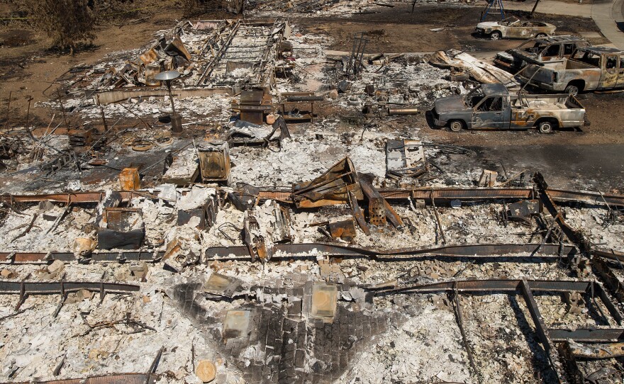 Destroyed homes and vehicles scorched by the Valley Fire line Jefferson Street in Middletown, Calif. Nearly half the community was destroyed.