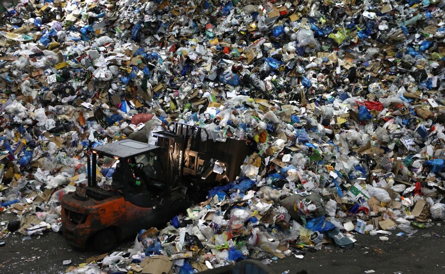 A worker operates a forklift to move household waste at a facility that stores recyclable materials in Seoul, South Korea. In 2019, more than 130 million metric tons of single-use plastics were thrown away, according to a new report.