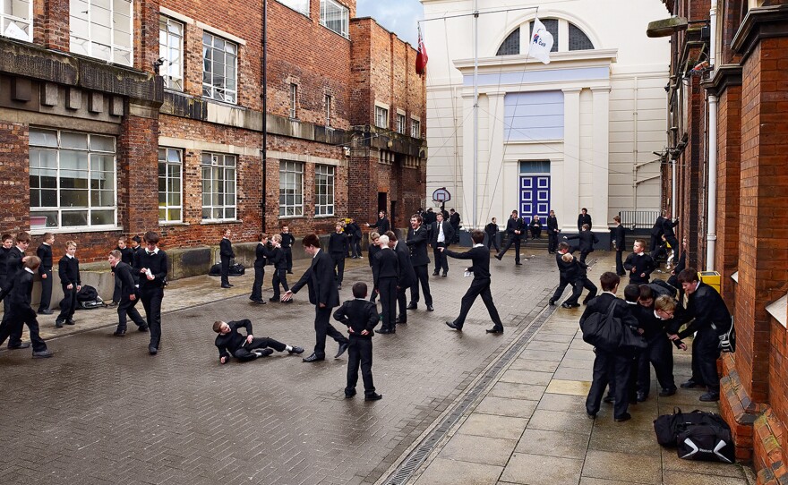 Teens take a break on a courtyard between classes at Hull Trinity House Academy, an all-boys school in the U.K.