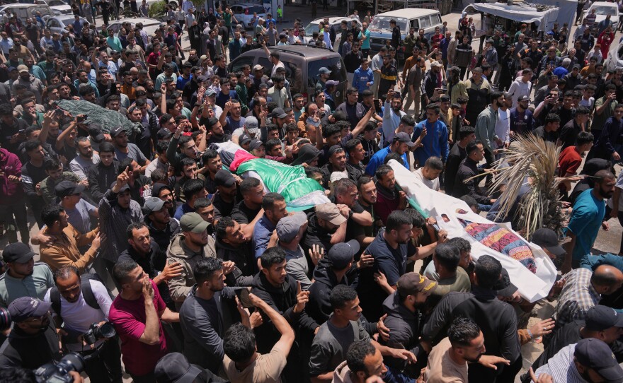 Palestinians carry the bodies of Izz al-Din al-Haddad, the leader of Hamas' Qassam Brigades, center, along with those of his daughter, right, and wife, who were killed in an Israeli strike, during their funeral in Gaza City, Saturday, May 16, 2026.