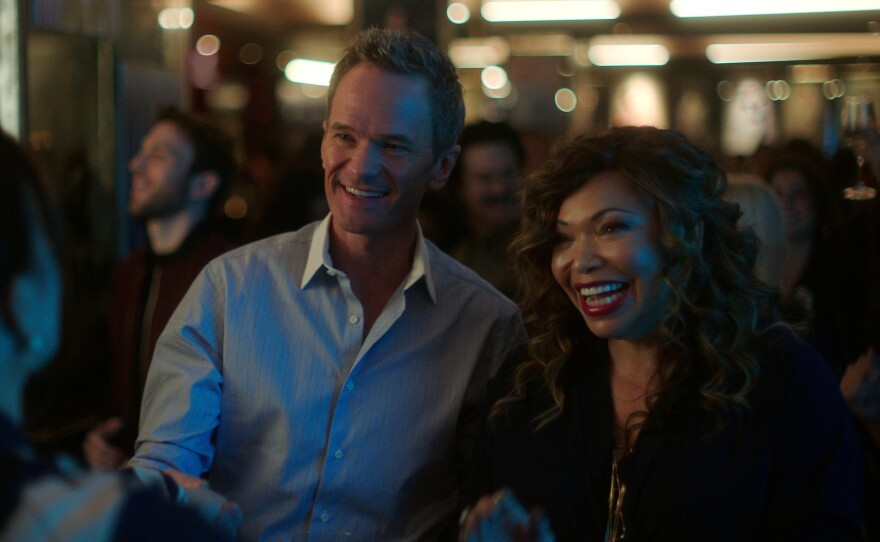 (L to R) Michael (Neil Patrick Harris) and pal Suzanne (Tisha Campbell) schmooze a prospective client.
