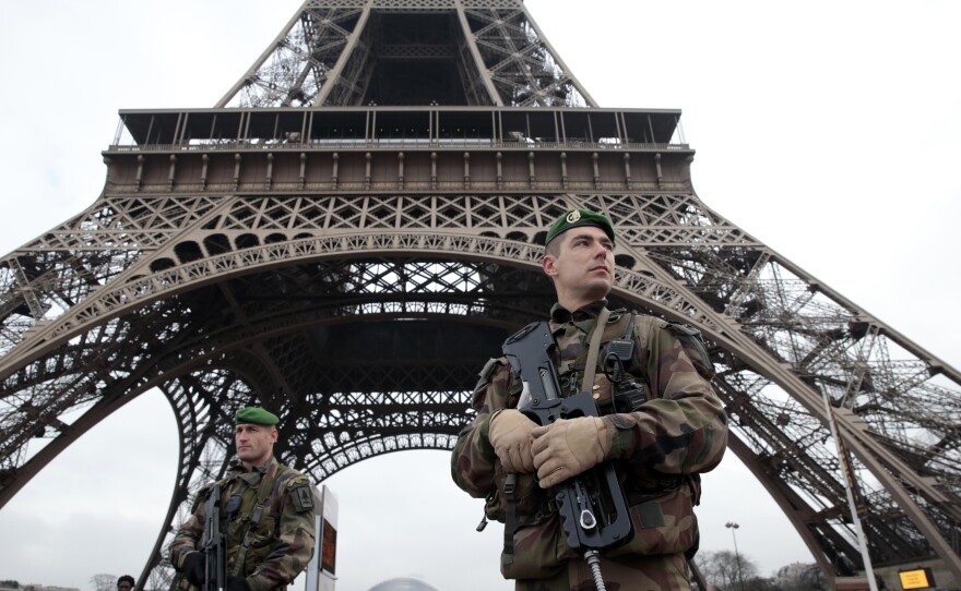 French soldiers patrol in front of the Eiffel Tower. The capital was placed under the highest alert status following the attack.
