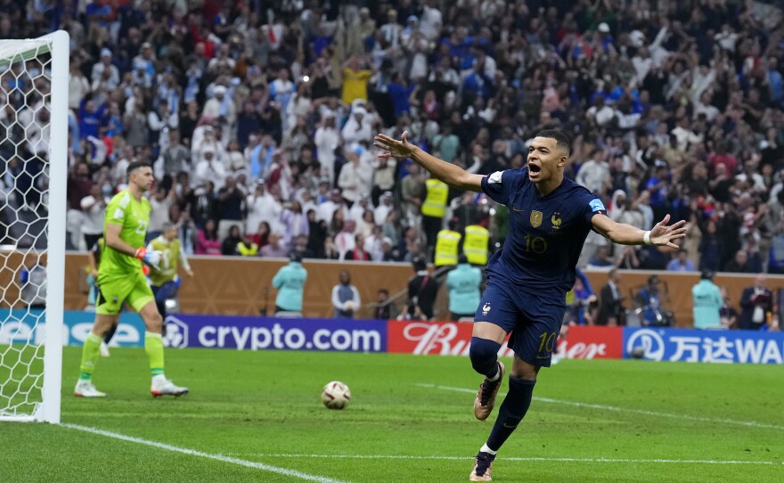 France's Kylian Mbappé celebrates scoring his side's third goal during a penalty shootout to settle the 2022 World Cup final with Argentina on Sunday, Dec. 18, at the Lusail Stadium in Lusail, Qatar.