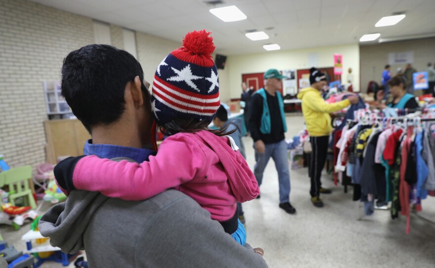Immigrants choose donated clothing at the Catholic Charities Respite Center on Jan. 6, 2017 at the Sacred Heart Catholic Church in McAllen, Texas. The center helps thousands of immigrants.