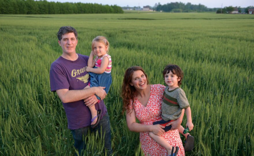 Ben, Vivian and the twins knee deep in the fields outside of their Deep Run home.