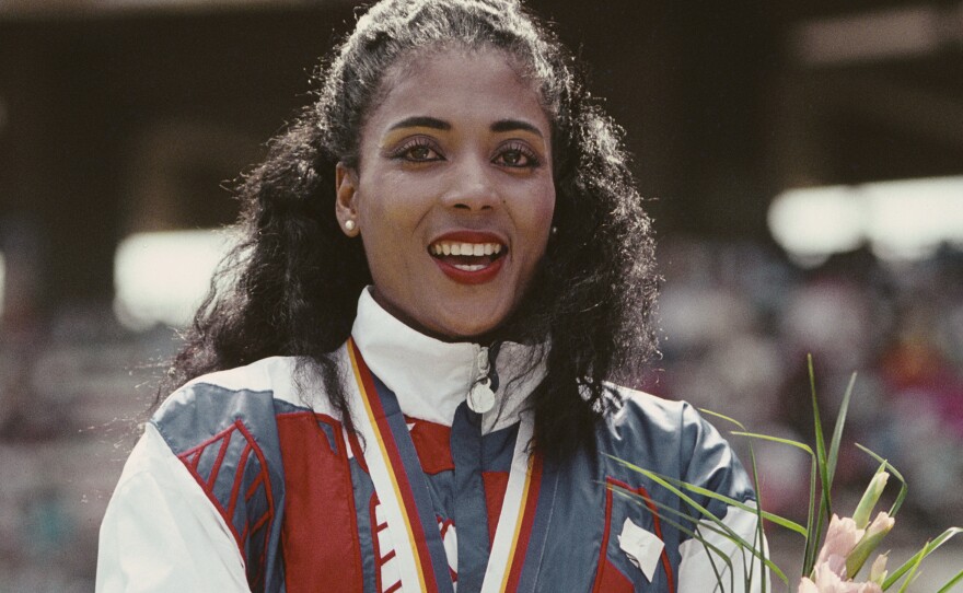 Florence Griffith-Joyner celebrates with her gold medal after winning the Women's 100 meters final event during the 1988 Summer Olympic Games in Seoul, South Korea.