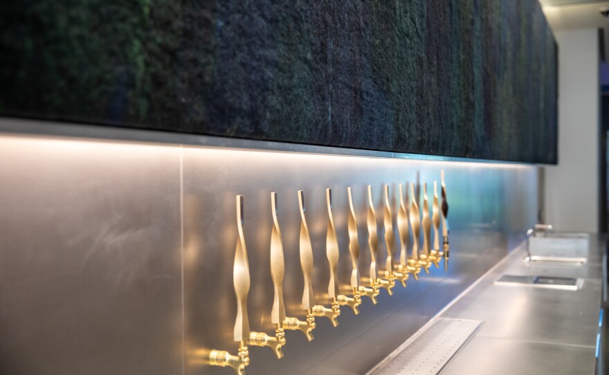 Claudy Jongstra's wool mural, "Truth and Beauty In Black" is installed above the Mingei's new bar, Artifact. The taps were designed by architect Jennifer Luce to mimic Hedgerow, the new outdoor fence.