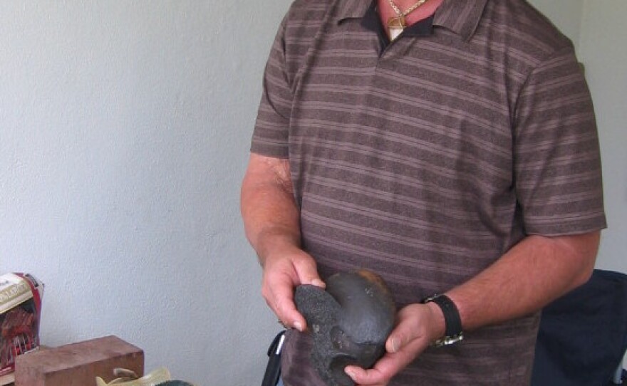 Amateur collector James Kennedy with some of the fossils he's collected in Florida. Kennedy found the carved bone four or five years ago, but didn't notice the carving until a few years later when he cleaned it.