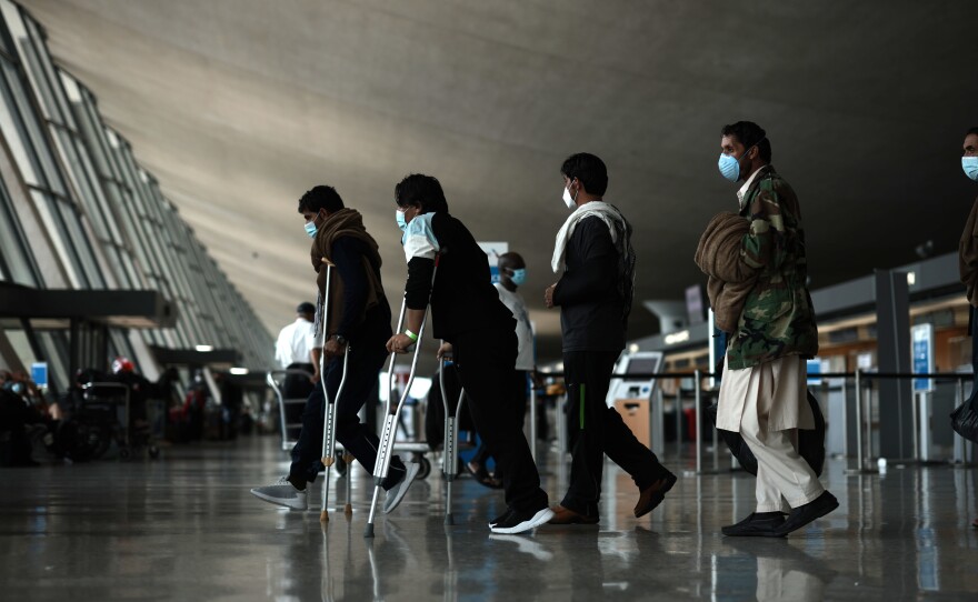 Refugees arrive at Dulles International Airport in Virginia on Tuesday after being evacuated from Kabul following the Taliban takeover of Afghanistan.