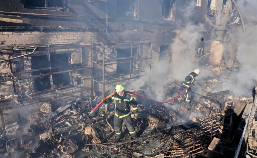 Firefighters put out the fire at a residential neighbourhood following a Russia missile and drone attack, in Brovary, close to Kyiv, Ukraine, on Saturday.