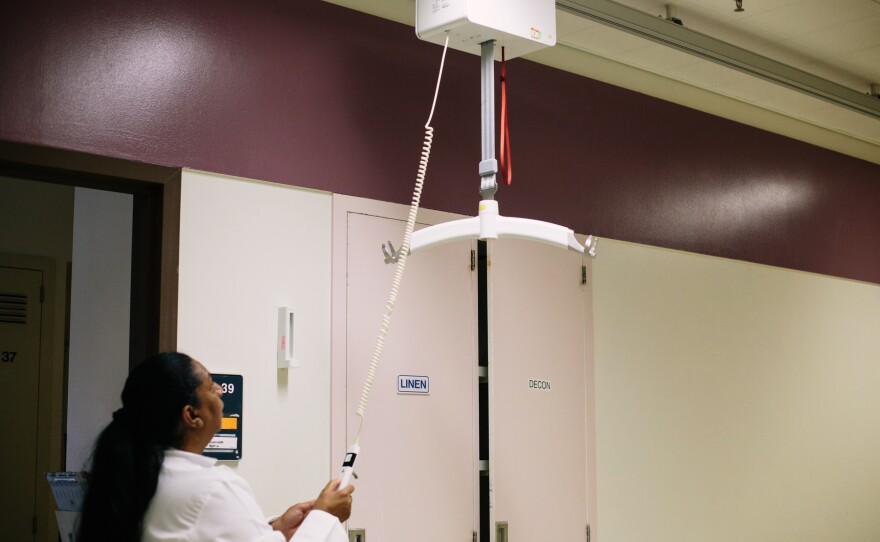 Tony Hilton, the safe patient handling and mobility coordinator at the VA hospital in Loma Linda, demonstrates one of the hospital's lifts.