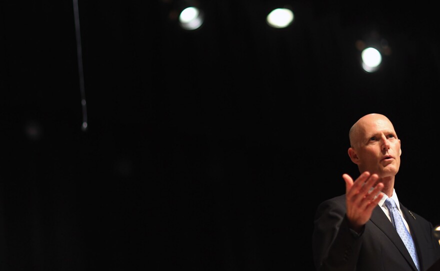 The federal government has awarded about $67 million in grants to groups around the country that will help people shop for health coverage. But Florida Gov. Rick Scott says the guidelines for these so-called navigators are inadequate.