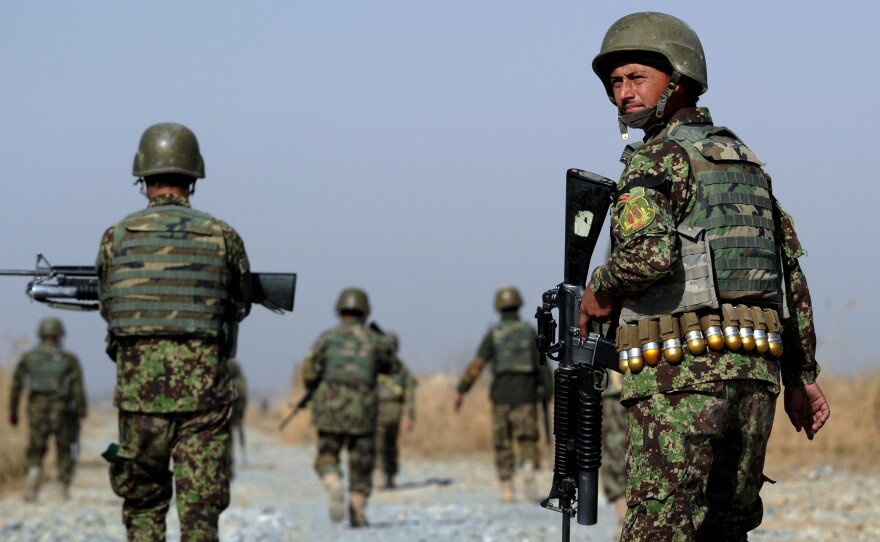 Afghan soldiers patrol a rural road near in southern Afghanistan. U.S. forces will continue to train Afghans on logistics and intelligence collection.